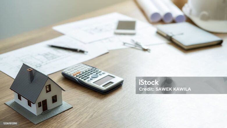 Engineering or Architect tools, blueprint and house model on table in office. Construction concept.